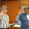 Ron Conger, left, and Rodney Wells are sworn in as new Council members by attorney Joe Brannon, not pictured.